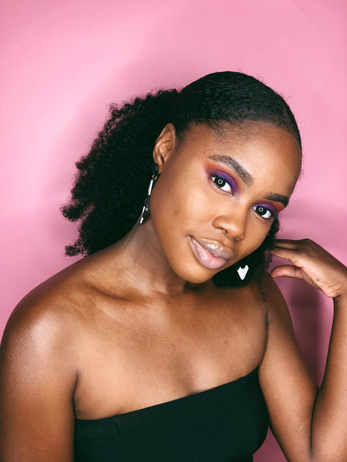 Portrait of Woman Wearing Black Tube Top on Pink Background