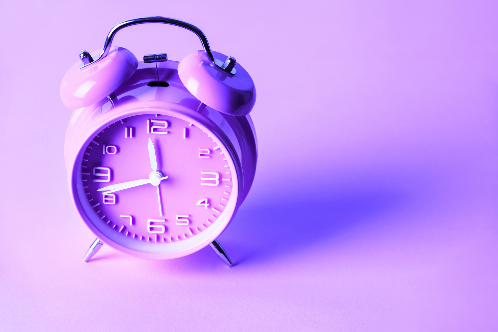 Purple Alarm Clock on Neon Purple Background