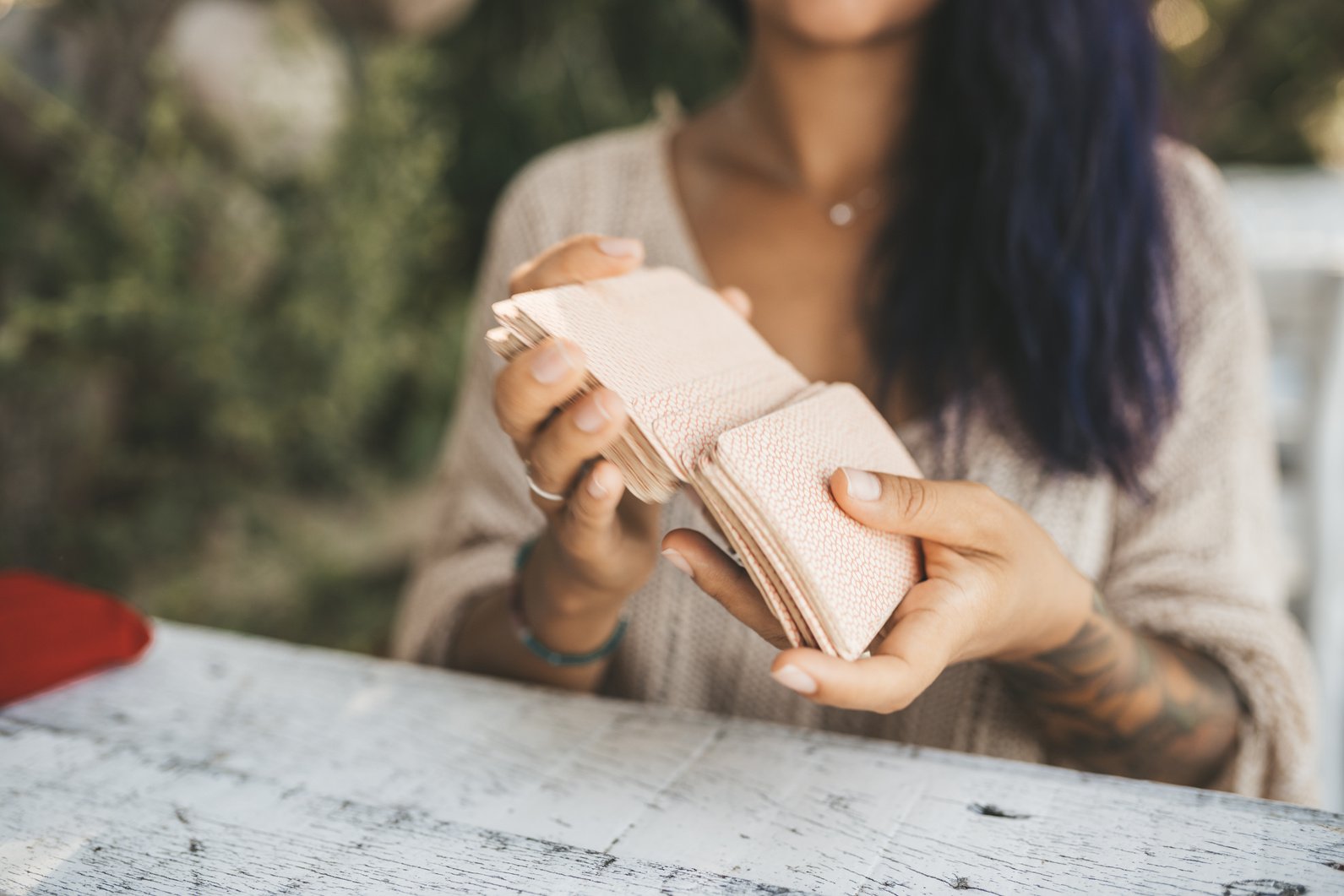 Close uo of female hands with Tarot cards